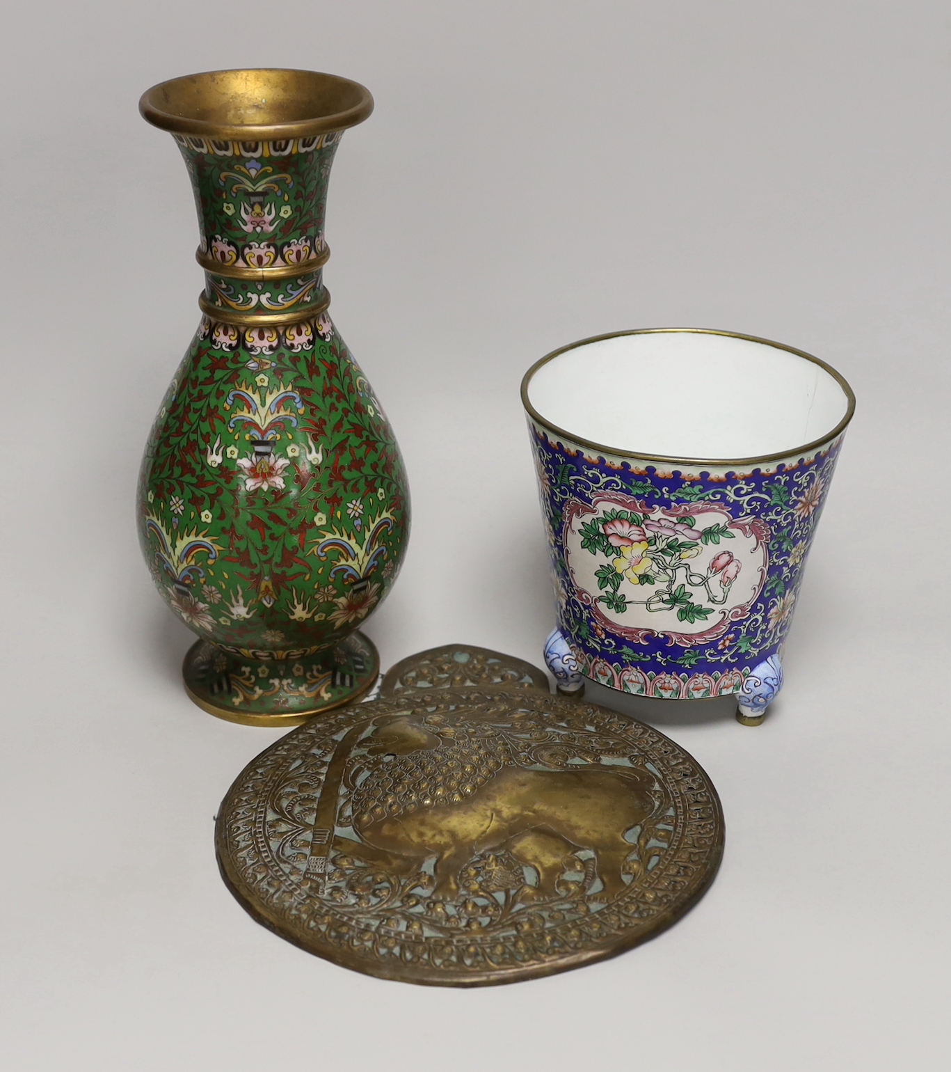 A Chinese Guangzhou enamel vase, a cloisonné enamel vase and an Indonesian brass panel, tallest 26cm high